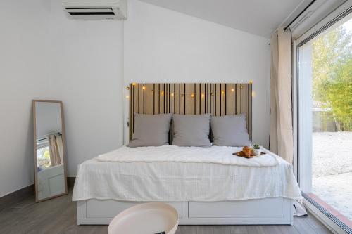a bedroom with a large bed with a teddy bear on it at Aréva - Provençal - Climatisé - Parking in Ventabren