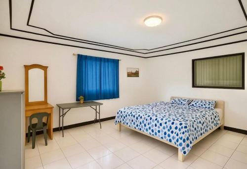 une chambre avec un lit, une table et une fenêtre dans l'établissement Namaste Olango Guesthouse by Hiverooms, à Sampong