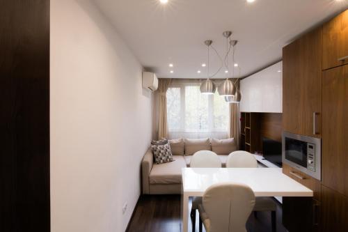 a living room with a couch and a table at Lozenets Apartment in Sofia
