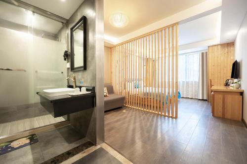 a bathroom with a sink and a bath tub at Huayi Hotel in Shanghai