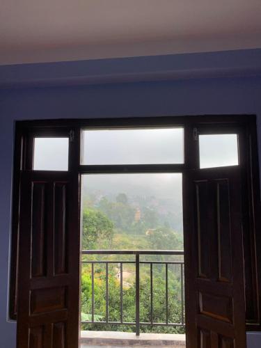 an open door to a balcony with a view at DIPSAGAR Hotel And Lodge in Bandīpur