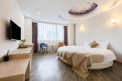 a hotel room with a bed and a television at Huayi Hotel in Shanghai