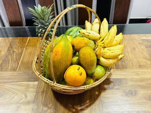 a basket of fruit sitting on a table at Pearl Paradise Villa in Awariwatta
