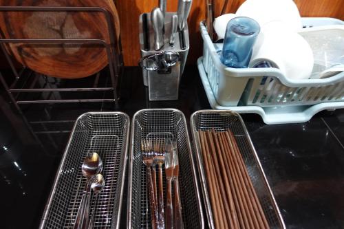 a kitchen counter with utensils in a dish drying rack at Sen Sapa Retreat & Tours in Sa Pa