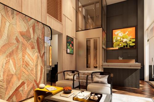 a lobby with two chairs and a table at HAITA Suites in Ho Chi Minh City