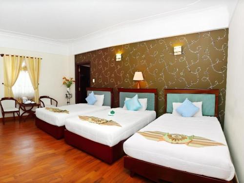 Ένα ή περισσότερα κρεβάτια σε δωμάτιο στο Universe Hotel