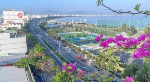 a view of a city street with purple flowers at Ocean View Danang Hotel in Da Nang