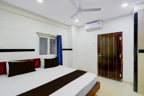 a bedroom with a bed and a window at Hotel O S V Residency in Vidya Nagar
