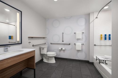 a bathroom with a toilet and a sink and a tub at Tru By Hilton Flagstaff in Flagstaff