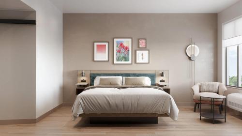 a bedroom with a large bed and a chair at Cambria Hotel Euless - DFW Airport South in Euless