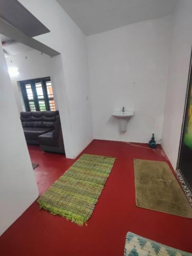 a living room with a rug on the floor at Cuba beach villa in Alleppey