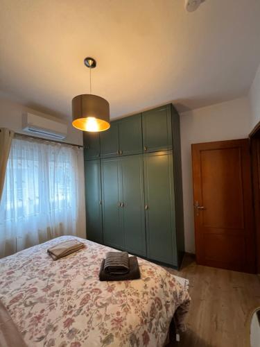 a bedroom with a bed and a green cabinet at Da Iro in Larisa