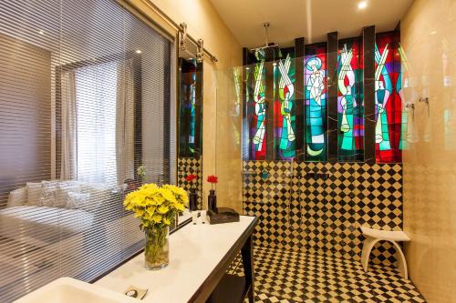 a bathroom with a sink and stained glass windows at Quentin Boutique Hotel in Berlin