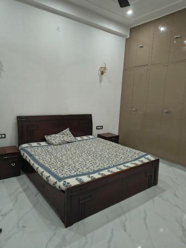 a bedroom with a bed with a wooden frame at C-57, Nitin khandelwal in Jaipur