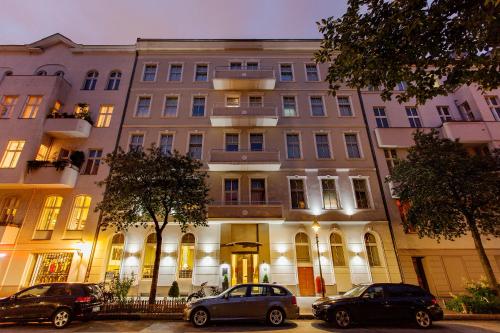 un bâtiment avec des voitures garées devant lui dans l'établissement Quentin Design Hotel Berlin, à Berlin