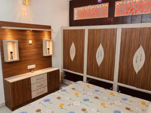 a bedroom with a bed and a wooden wall at Urban Retreat in Agra