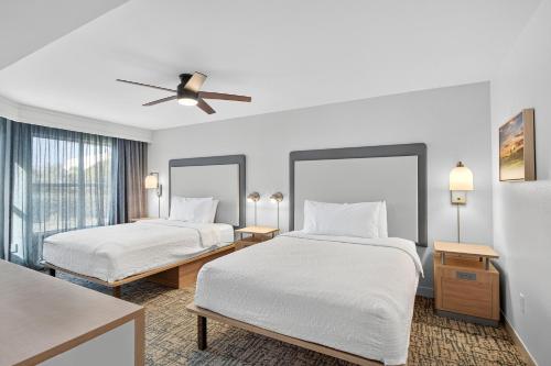 a hotel room with two beds and a ceiling fan at Homewood Suites by Hilton Carlsbad-North San Diego County in Carlsbad
