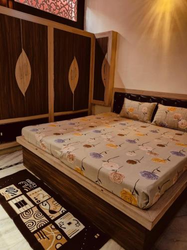 a bedroom with a bed with a wooden headboard at Urban Retreat in Agra
