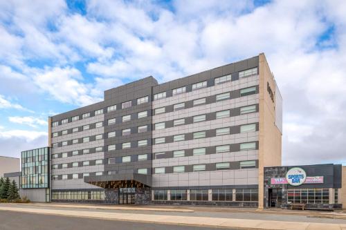 a large office building on a city street at Lakeview Signature, Trademark Collection by Wyndham in Winnipeg