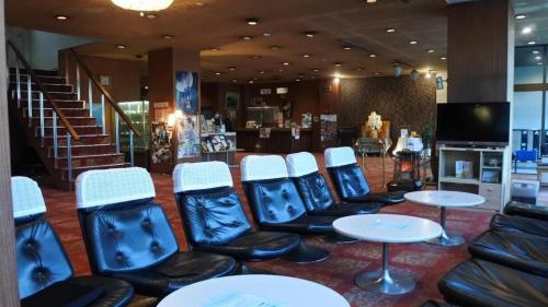 a waiting room with chairs and tables in a store at Inuyamakan in Inuyama