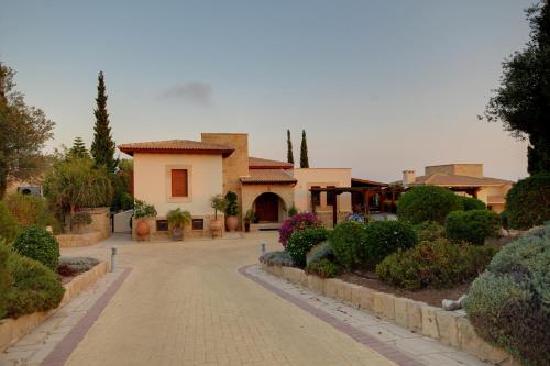 a house with a cobblestone street in front at Villa UNIDERA in Kouklia