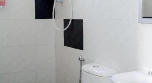 a white bathroom with a shower and a toilet at Hotel Darulaman Alor Setar in Alor Setar