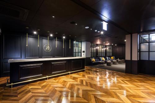 a room with a wooden floor and a bar at Hotel28 Myeongdong in Seoul