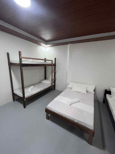 a room with two beds and a shelf at Bergon Homestay in Burgos