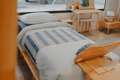 a bed with a wooden frame in a room at Bilik-Bilik by MUO in Seremban