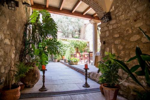 a hallway with potted plants in a stone building at Hotel Boutique Posada Dos Orillas in Trujillo