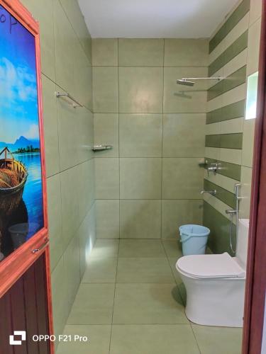 a bathroom with a toilet and a shower at sea scape homestay in Mararikulam