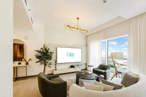 a living room with a couch and chairs and a tv at FAM Living - 3 bedroom and Maids Room Retreat Overlooking Dubai Canal in Dubai