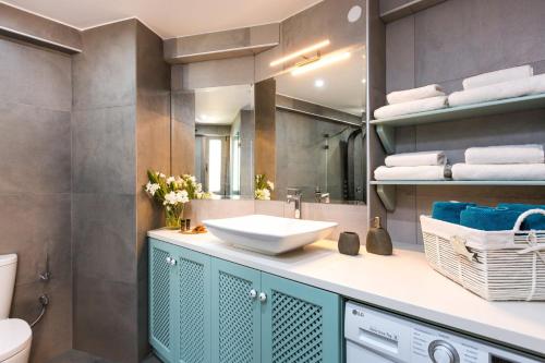a bathroom with a sink and a mirror at Philoxenia Residences in Panormos Rethymno