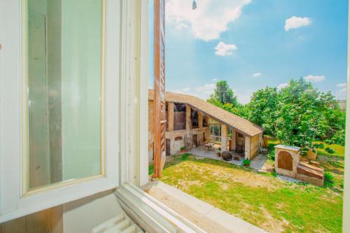 a view of a house from an open window at Ancient farmhouse 