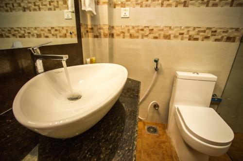 a bathroom with a sink and a toilet at Hotel Encounter Nepal & Spa in Kathmandu