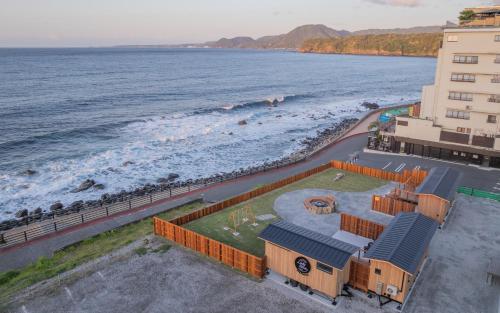 an aerial view of a building next to the ocean at Lady Blue伊豆稲取 in Higashiizu