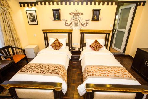 a hotel room with two beds in a room at Hotel Encounter Nepal & Spa in Kathmandu