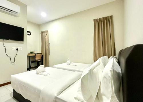 a hotel room with two beds and a television at Swing & Pillows - Salak Tinggi , KLIA 1 KLIA 2 in Sepang