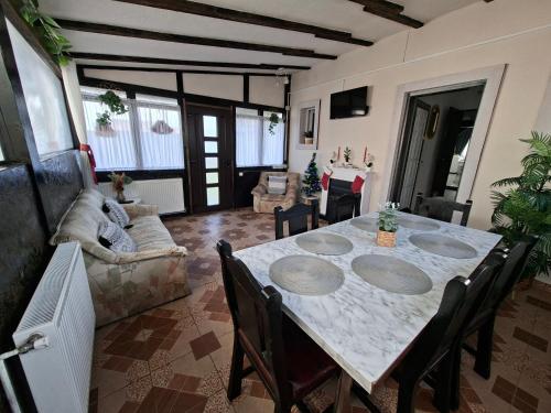 a living room with a table and a couch at Căsuța Piatra Craiului in Zărneşti