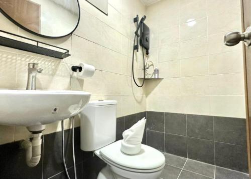 a bathroom with a toilet and a sink and a phone at Swing & Pillows - Salak Tinggi , KLIA 1 KLIA 2 in Sepang