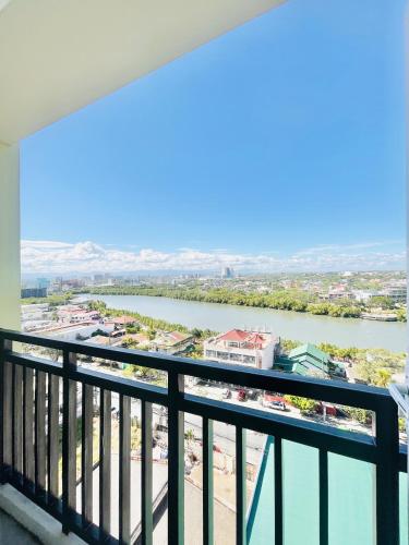 a view of a river from a balcony at Bernwood Tower in Iloilo City