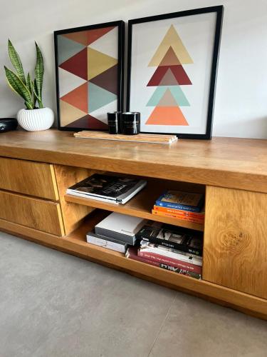 a wooden shelf with two pictures on top of it at הסטודיו in Beer Sheva