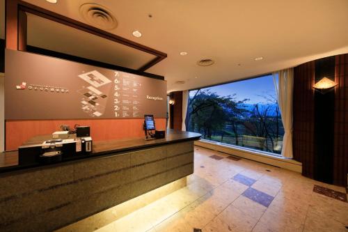 a bar in a hotel lobby with a large window at Yutorelo Echigoyuzawa in Yuzawa