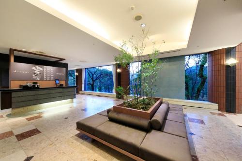 a living room with a couch and a large window at Yutorelo Echigoyuzawa in Yuzawa