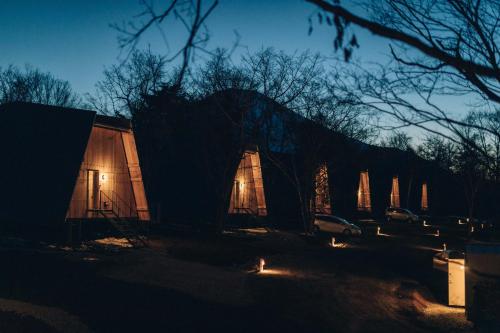 a building at night with a car parked next to it at SANU 2nd Home 山中湖1st in Yamanakako