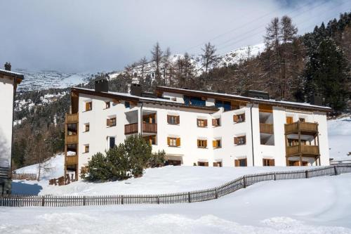 a building with snow in front of it at Chesa Aquileja Trüb in Pontresina