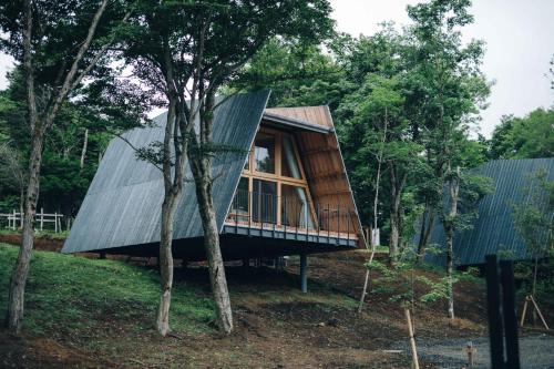 a tree house with a metal roof at SANU 2nd Home 山中湖1st in Yamanakako