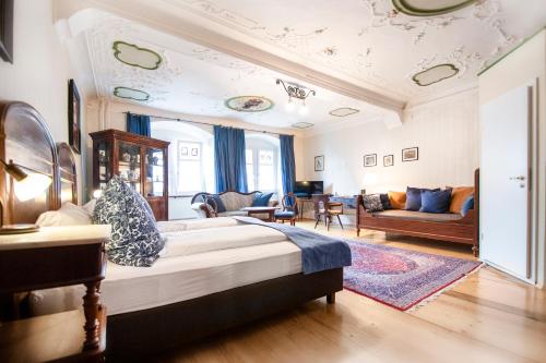 a bedroom with a bed and a living room at Romantik Hotel Barbarossa in Konstanz