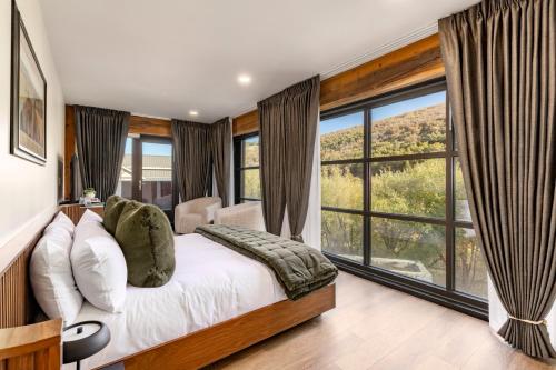 a bedroom with a bed and a large window at Main & SKY by EXMAR in Park City