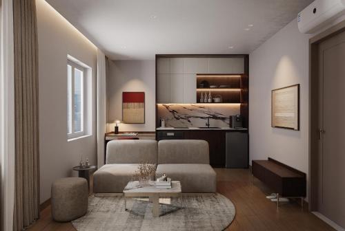 a living room with a couch and a table at HAITA Suites in Ho Chi Minh City